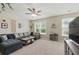 Spacious living room with plush carpet, lots of natural light, modern ceiling fan, and comfortable sectional sofa at 771 Tulip Poplar Way, Lawrenceville, GA 30044