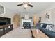 Cozy living room features a fireplace, plush carpet, neutral paint, updated ceiling fan, and comfortable furnishings at 771 Tulip Poplar Way, Lawrenceville, GA 30044