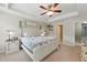 Bright main bedroom featuring a trey ceiling, ceiling fan, and a decorative wooden headboard at 771 Tulip Poplar Way, Lawrenceville, GA 30044