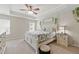 Bright main bedroom features a tray ceiling, ceiling fan, large windows and an ensuite bathroom at 771 Tulip Poplar Way, Lawrenceville, GA 30044