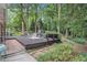 Large wooden deck is surrounded by lush trees and foliage, creating a private backyard oasis at 1747 Remington Rd, Atlanta, GA 30341