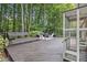 Spacious backyard with a deck area featuring built-in benches, seating, and lush greenery at 1747 Remington Rd, Atlanta, GA 30341