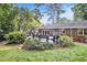 Spacious backyard featuring a well-maintained lawn, deck with seating, and lush landscaping at 1747 Remington Rd, Atlanta, GA 30341