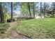 Over-sized backyard with a lush lawn, mature trees, and a quaint deck at rear of home at 1747 Remington Rd, Atlanta, GA 30341
