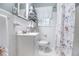 Clean bathroom with white tiling, a floral shower curtain, and a window for natural light at 1747 Remington Rd, Atlanta, GA 30341