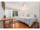 This bedroom features hardwood floors, a ceiling fan, and a window bench with built-in storage at 1747 Remington Rd, Atlanta, GA 30341