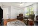 Bright bedroom with hardwood floors, natural light, two arm chairs, and a ceiling fan at 1747 Remington Rd, Atlanta, GA 30341