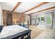 Bright dining room boasts exposed brick accent wall, wood beams, and sliding glass doors to the backyard at 1747 Remington Rd, Atlanta, GA 30341