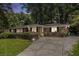 Well-maintained brick home with lush landscaping, long driveway, and black shutters at dusk at 1747 Remington Rd, Atlanta, GA 30341