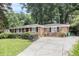 Well-maintained brick home with lush landscaping, long driveway, and black shutters at 1747 Remington Rd, Atlanta, GA 30341