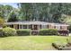 Charming brick home with manicured lawn and mature trees provides great curb appeal at 1747 Remington Rd, Atlanta, GA 30341
