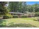 Charming brick home with manicured lawn and mature trees provides great curb appeal at 1747 Remington Rd, Atlanta, GA 30341