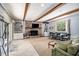 Inviting living room with exposed brick fireplace, beamed ceilings, built-in bookshelves and tile flooring at 1747 Remington Rd, Atlanta, GA 30341