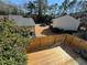 Elevated view of a wooden deck with a privacy fence and nearby building at 731 Hanover Se Ln, Marietta, GA 30067