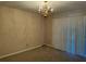 Dining room with carpet, vertical blinds, and decorative chandelier lighting at 731 Hanover Se Ln, Marietta, GA 30067