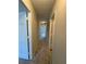 A carpeted hallway with white doors and textured ceiling in a home at 731 Hanover Se Ln, Marietta, GA 30067