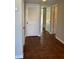 Hallway with wood-look tile flooring, neutral paint and various doorways to rooms in the home at 731 Hanover Se Ln, Marietta, GA 30067