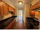 Galley kitchen featuring tile floors, dark countertops, and stainless steel appliances at 731 Hanover Se Ln, Marietta, GA 30067