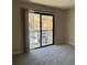 Spacious living room featuring sliding glass doors to a balcony with a parking area view at 731 Hanover Se Ln, Marietta, GA 30067