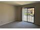 Bright living room showcasing sliding glass doors leading to a balcony with a parking area view at 731 Hanover Se Ln, Marietta, GA 30067