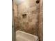 The shower has tiled walls accented with a decorative tile border and a shampoo nook at 731 Hanover Se Ln, Marietta, GA 30067