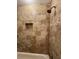 The shower boasts tiled walls accented with a decorative tile border and a shampoo nook at 731 Hanover Se Ln, Marietta, GA 30067