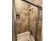 The shower boasts tiled walls and a convenient shampoo nook for storage at 731 Hanover Se Ln, Marietta, GA 30067