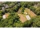 Expansive aerial view of the property featuring a pond, agricultural fields, and mature trees at 1001 Dancing Fox Rd, Decatur, GA 30032