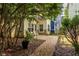 Serene backyard with gravel pathway, lush greenery, and a private setting at 1001 Dancing Fox Rd, Decatur, GA 30032