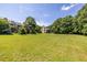 Expansive backyard featuring a large lawn and mature trees, ideal for outdoor activities at 1001 Dancing Fox Rd, Decatur, GA 30032