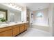 Bright bathroom with a double sink vanity, soaking tub, shower, and a neutral color scheme at 1001 Dancing Fox Rd, Decatur, GA 30032