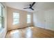 Bedroom featuring light hardwood floors, a ceiling fan, two bright windows and a door at 1001 Dancing Fox Rd, Decatur, GA 30032
