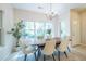 Bright dining room with a modern chandelier and a large window view of the outdoors at 1001 Dancing Fox Rd, Decatur, GA 30032
