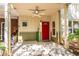 Inviting covered front porch featuring a ceiling fan and a bright red front door at 1001 Dancing Fox Rd, Decatur, GA 30032