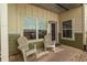 Covered front porch with two white chairs and a purple front door at 1001 Dancing Fox Rd, Decatur, GA 30032
