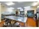 A large commercial kitchen provides ample space and features stainless steel appliances and workspaces at 1001 Dancing Fox Rd, Decatur, GA 30032