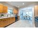 Spacious kitchen leading to a dining room, features wood cabinets, tile floor and countertops at 1001 Dancing Fox Rd, Decatur, GA 30032