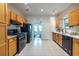 Functional kitchen with black appliances, wood cabinets, and tile flooring at 1001 Dancing Fox Rd, Decatur, GA 30032