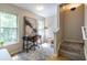 Office space featuring a modern desk, chair, natural lighting, and decor with adjacent carpeted stairs at 1001 Dancing Fox Rd, Decatur, GA 30032