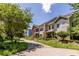 Street view of townhomes with manicured lawns, lush greenery, and curb appeal at 1001 Dancing Fox Rd, Decatur, GA 30032