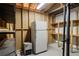 Unfinished basement featuring bare framing and a fridge, ideal for customization or added storage space at 1974 Skyland Glen Dr, Snellville, GA 30078