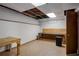 An unfinished basement with tile floors, perfect for customizing as a workshop or additional storage space at 1974 Skyland Glen Dr, Snellville, GA 30078