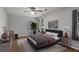 This cozy bedroom features neutral walls, ceiling fan and large windows with ample natural light at 1974 Skyland Glen Dr, Snellville, GA 30078