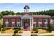 Exterior elevation of a brick municipal building with white columns, a clock cupola, brick stairs, and landscaping at 1974 Skyland Glen Dr, Snellville, GA 30078
