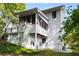 Rear exterior view of the home, highlighting the screened porch, deck, and walkout basement access at 1974 Skyland Glen Dr, Snellville, GA 30078