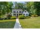 Inviting two-story house with a well-manicured lawn and mature trees at 1974 Skyland Glen Dr, Snellville, GA 30078