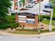 A sign for Presidential Markets and nearby retail stores surrounded by manicured landscaping and parking at 1974 Skyland Glen Dr, Snellville, GA 30078