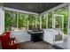 Enjoy the outdoors bug-free on this screened porch with serene backyard views and a grill at 1974 Skyland Glen Dr, Snellville, GA 30078