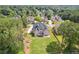 Aerial view of the brick home with a lush lawn, deck, and driveway at 2548 Westchester Se Way, Conyers, GA 30013