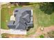 Aerial view of a home with a dark roof, deck, and manicured green lawn at 2548 Westchester Se Way, Conyers, GA 30013